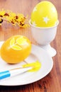 Painting easter eggs in yellow color
