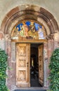 Painting entrance to San Michele church in San Candido