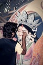 Painting the Eye over clay Idol of Hindu Goddess Durga. An idol making process of Pottery Artist at Kumartuli during Durga Puja