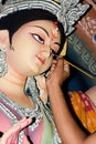 Painting the Eye over clay Idol of Hindu Goddess Durga. An idol making process of Pottery Artist at Kumartuli during Durga Puja