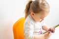 Painting is fun for kids - baby girl plays with the paint with dirty hands. Little beautiful girl of Slavic appearance Royalty Free Stock Photo