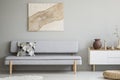 Painting on grey wall above settee with cushion in modern living Royalty Free Stock Photo