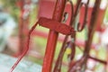 Painting the grilles of an old glider swing made of wrought iron with red oxide primer paint. Using a small paint roller. Royalty Free Stock Photo