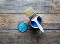 Painting at home with can blue paint on wooden background Royalty Free Stock Photo