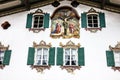 Painting house wall with crucifixion in village Oberammergau, Bavaria, Germany