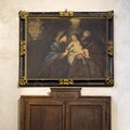 Painting of the infant Jesus in the arms of Joseph and the gaze of Mary in the Basilica of Saint James in Bellagio, Italy.