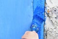 Painting iron surfaces with a blue paint brush