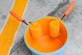 Painting in a orange color. Paint can with roller brush Royalty Free Stock Photo