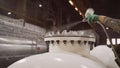 Painting parts at a metalworking plant. Worker paints a large part at a factory