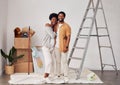 Painting, portrait or home with a black couple in DIY, renovation or house remodel with a paintbrush or roller. Teamwork Royalty Free Stock Photo