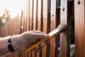 Painting protective varnish on wooden picket fence