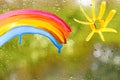 painting rainbow, yellow sun on glass, rain outside window, gouache, acrylic, creative development, texture background with water Royalty Free Stock Photo