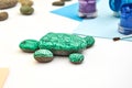 Painting a rock green turtle on a stone step by step. Children art project. DIY concept. Step by step photo instruction