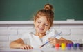 Painting school lesson, drawing art. Cute little girl child painting with paints color and brush. Drawing lesson in Royalty Free Stock Photo