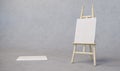 Painting stand wooden easel with blank canvas poster sign board isolated on concrete texture background