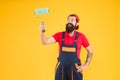 Painting tool. Brush roller painter. Decoration and decor. Man bearded laborer painting in workshop. Repair and Royalty Free Stock Photo