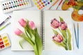 Painting of tulips in sketchbook, flowers and drawing supplies on white background, flat lay