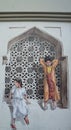 Painting Of Two Young Children On A Window