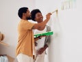 Painting, wall or home with a black couple in DIY, renovation or house remodel together with a paintbrush. Teamwork Royalty Free Stock Photo