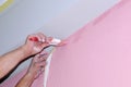 Painting wall of room. painting voids after masking tape. hands in the paint, close-up Royalty Free Stock Photo