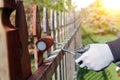 Painting wooden fence with brown paint outside