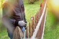 Painting wooden fence with brown paint outside