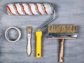 Painting work concept. set of tools for painting and repairing walls. roller and brush on gray background