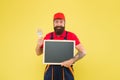 Painting works. Bearded decorator hold blackboard copy space. Repair tips. Happy hours. Man worker with paint brush Royalty Free Stock Photo