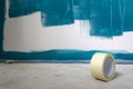 Painting works on a wall. With a roll of duct tape in the foreground. Work in progress. Royalty Free Stock Photo