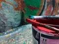 Painting and writing on a public wall, making graffiti in the street with colorful cans of paint_street art concept Royalty Free Stock Photo