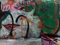 Painting and writing on a public wall, making graffiti in the street with colorful cans of paint_street art concept Royalty Free Stock Photo