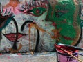 Painting and writing on a public wall, making graffiti in the street with colorful cans of paint_street art concept Royalty Free Stock Photo