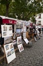 Paintings and cafes in Place du Tertre in Montmartre. Royalty Free Stock Photo