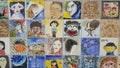 Paintings and sculpted faces of people on the wall for memoir