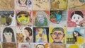 Paintings and sculpted faces of people on the wall for memoir