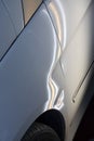 Paintless dent on white car Royalty Free Stock Photo