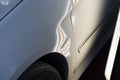 Paintless dent on white car