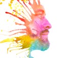 Paintography. Double exposure profile portrait of a man with strong features combined with handmade painting of colorful cloudy