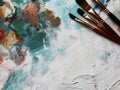 Paints and brushes, background with copy space in the middle, influenced by paint palette, brushes Royalty Free Stock Photo