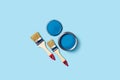 Paints and brushes on a blue background. Royalty Free Stock Photo