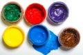 Paints in jars and a brush on a white sheet of paper Royalty Free Stock Photo