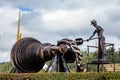 Beautiful industrial art sculpture by Jose Medardo Leguizamo of a man using coal to generate