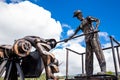 Beautiful industrial art sculpture by Jose Medardo Leguizamo of a man using coal to generate