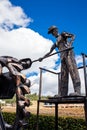 Beautiful industrial art sculpture by Jose Medardo Leguizamo of a man using coal to generate