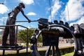 Beautiful industrial art sculpture by Jose Medardo Leguizamo of a man using coal to generate