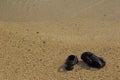 Brown sandals on a deserted beach Royalty Free Stock Photo