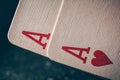 A pair of aces on a black background. Macro shot texture of playing cards. Ace of hearts and ace of diamonds. Nuts hand Royalty Free Stock Photo