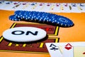 Pair of aces, blue chips and dealer chip ON on table in casino. Set for playing poker, bridge or blackjack. Bet played Royalty Free Stock Photo