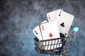 A pair of aces, hearts and diamonds, on a deck of playing cards. Poker playing chips in a blue shopping cart Royalty Free Stock Photo