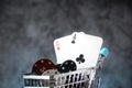 A pair of aces, hearts and diamonds, on a deck of playing cards. Poker playing chips on a dark and blue background. Royalty Free Stock Photo